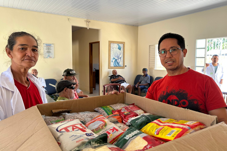 Imagem de caixa com alimentos não perecíveis arrecadados na Corrida da UFOB sendo entregue por professor Moabe Costa, do Centro Multidisciplinar de Santa Maria da Vitória